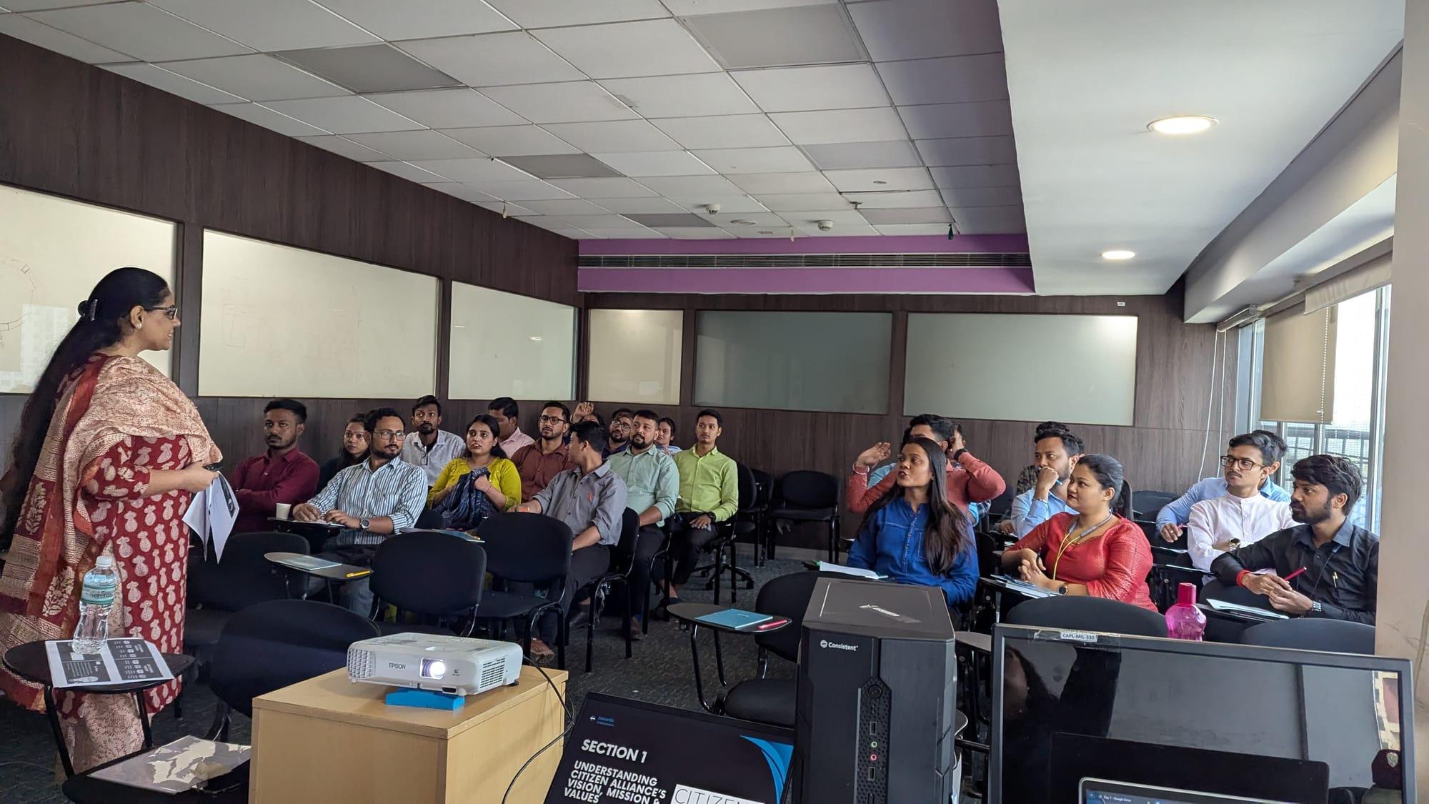 A facilitator presenting to a room of participants during a training session
